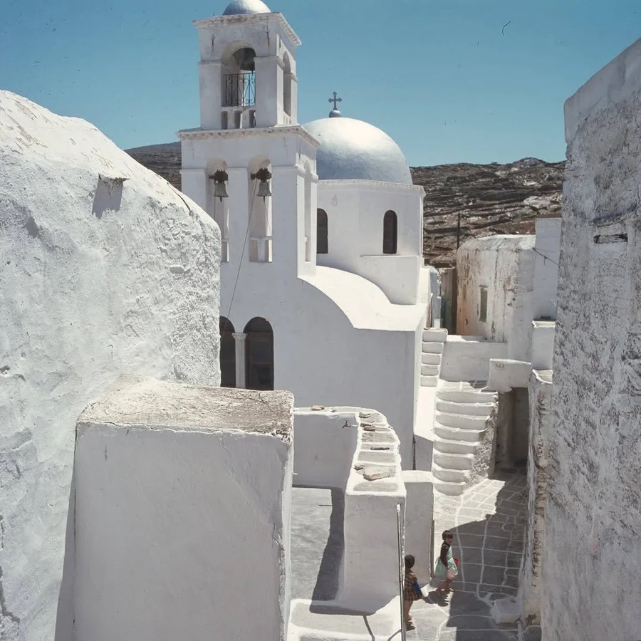 Whitewashed church and alley on a Greek island, by Konrad Helbig