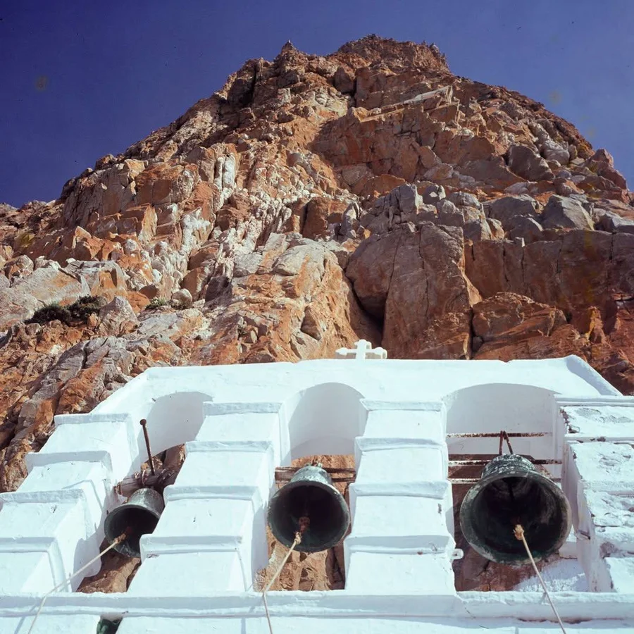Church bells against a rocky hillside, Greece, by Konrad Helbig