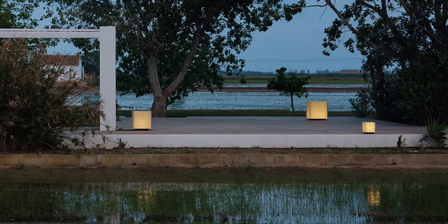 Shiro outdoor lamps by Antoni Arola for Santa & Cole, at dusk by a rice field